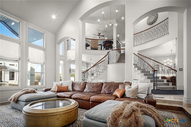 111 Western Oaks, New Braunfels, TX 78132 - living room featuring a notable chandelier, a high ceiling, arched walkways, and stairway