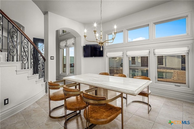 111 Western Oaks, New Braunfels, TX 78132 - dining area featuring arched walkways, stairs, light tile patterned flooring, and a notable chandelier