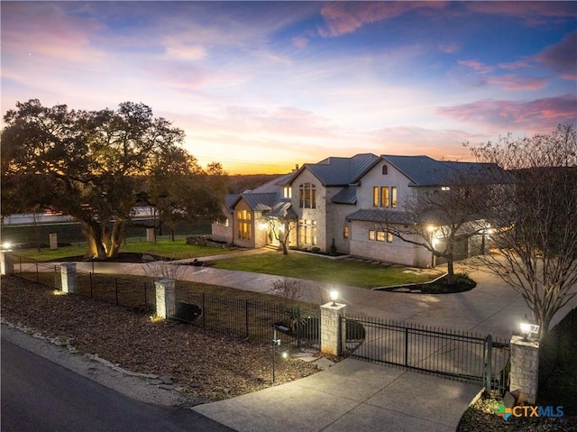 111 Western Oaks, New Braunfels, TX 78132 - view of front of property featuring a gate, a standing seam roof, curved driveway, metal roof, and a fenced front yard