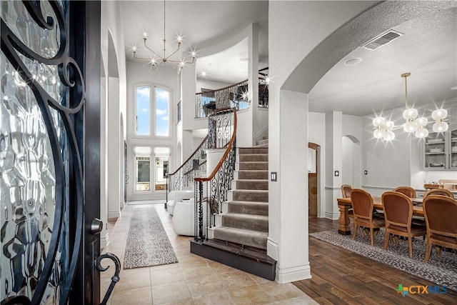 111 Western Oaks, New Braunfels, TX 78132 - entryway featuring stairs, a chandelier, arched walkways, visible vents, and wood finished floors