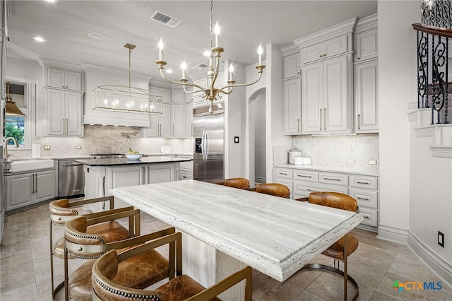 111 Western Oaks, New Braunfels, TX 78132 - kitchen with stainless steel appliances, a center island, a chandelier, a sink, and visible vents