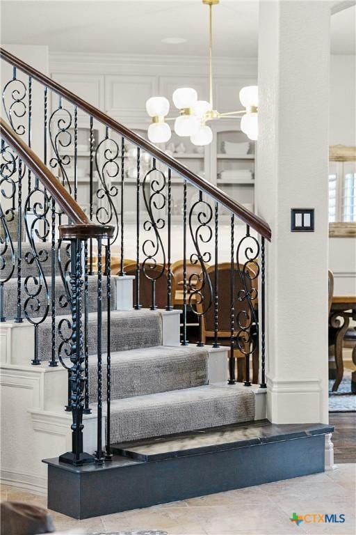 111 Western Oaks, New Braunfels, TX 78132 - stairs featuring a notable chandelier, a decorative wall, and ornamental molding