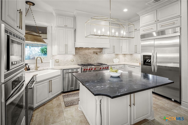 111 Western Oaks, New Braunfels, TX 78132 - kitchen featuring backsplash, a chandelier, a sink, built in appliances, and white cabinets