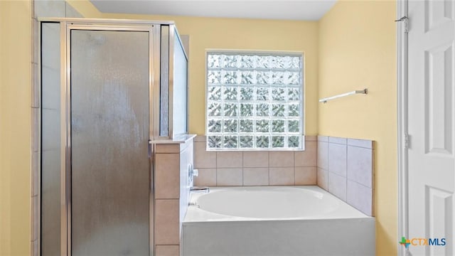 full bath featuring a shower stall and a bath