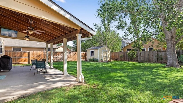 view of yard with a patio area, ceiling fan, a storage unit, and an outdoor structure