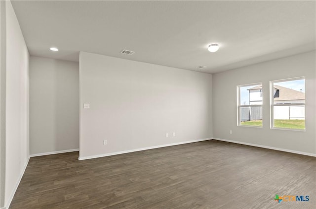 1211 N Teychas Dr, Kyle, TX 78640 - unfurnished room with dark wood-style flooring, baseboards, visible vents, and recessed lighting