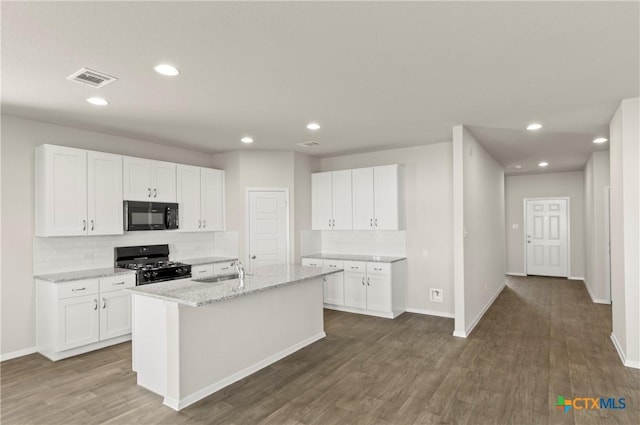 1211 N Teychas Dr, Kyle, TX 78640 - kitchen featuring dark wood-style floors, a sink, black appliances, and tasteful backsplash