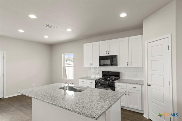 1211 N Teychas Dr, Kyle, TX 78640 - kitchen featuring visible vents, dark wood-style flooring, white cabinetry, a sink, and black appliances