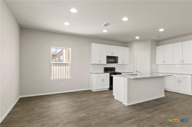 1211 N Teychas Dr, Kyle, TX 78640 - kitchen with visible vents, a sink, black appliances, and tasteful backsplash