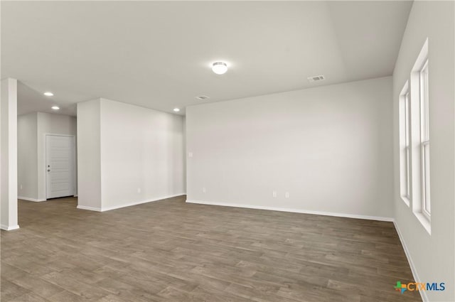 1211 N Teychas Dr, Kyle, TX 78640 - spare room with recessed lighting, baseboards, visible vents, and wood finished floors