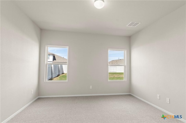 1211 N Teychas Dr, Kyle, TX 78640 - empty room with visible vents, a wealth of natural light, and light carpet