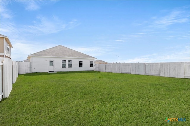 1211 N Teychas Dr, Kyle, TX 78640 - rear view of house with a yard and a fenced backyard