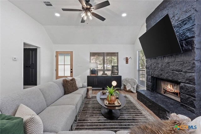 103 County Road 424b, Lorena, TX 76655 - living area with lofted ceiling, wood finished floors, a stone fireplace, ceiling fan, and recessed lighting