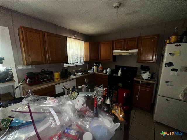 1402 N W S Young Dr, Killeen, TX 76543 - kitchen with white appliances, under cabinet range hood, brown cabinetry, a textured ceiling, and tile patterned flooring