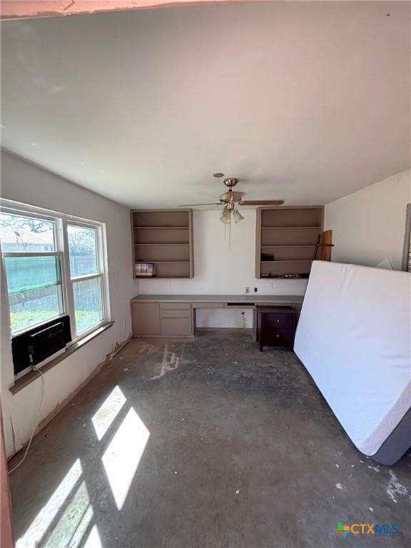 unfurnished bedroom featuring unfinished concrete flooring