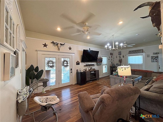 living area with recessed lighting, ceiling fan with notable chandelier, and dark wood-type flooring