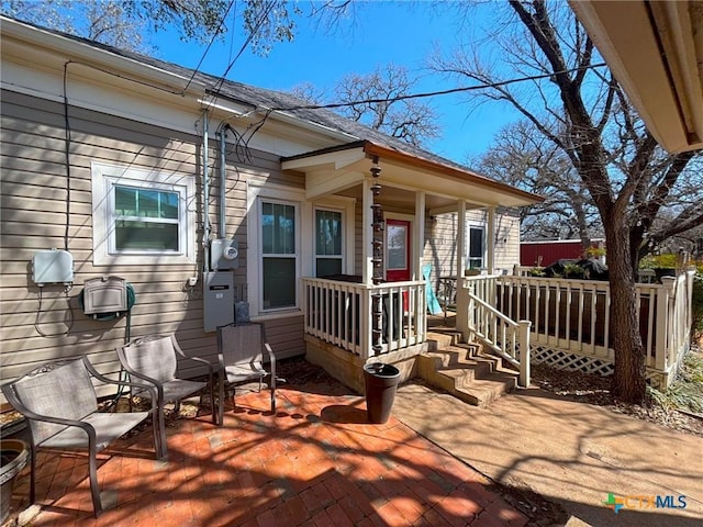 wooden deck featuring a patio area and a porch