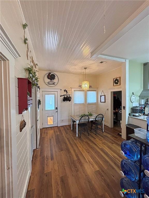 dining area featuring dark wood-type flooring and wood ceiling