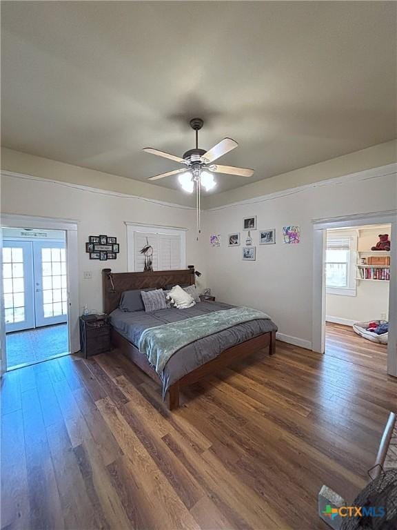 bedroom featuring a ceiling fan, wood finished floors, baseboards, and french doors