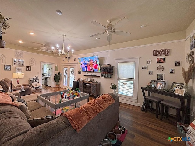 living room with french doors, wood finished floors, and ceiling fan with notable chandelier