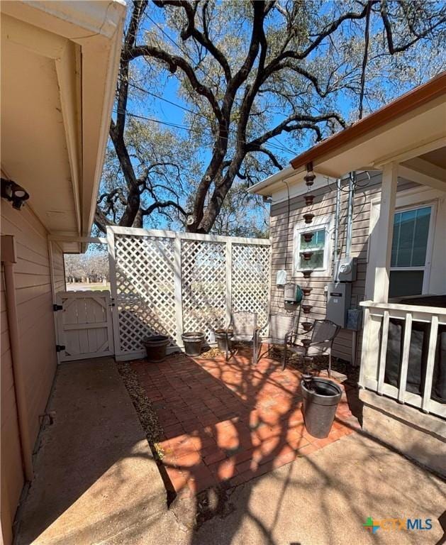 view of patio featuring fence and a gate