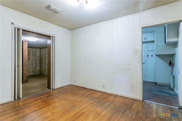 spare room with hardwood / wood-style flooring