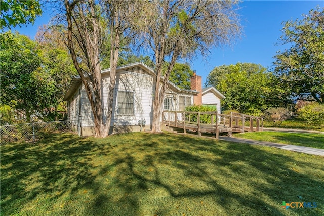 exterior space with a front yard and a deck