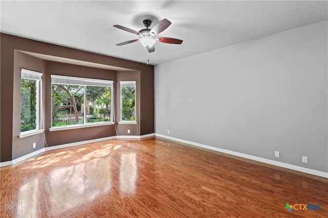 unfurnished room featuring ceiling fan and hardwood / wood-style flooring