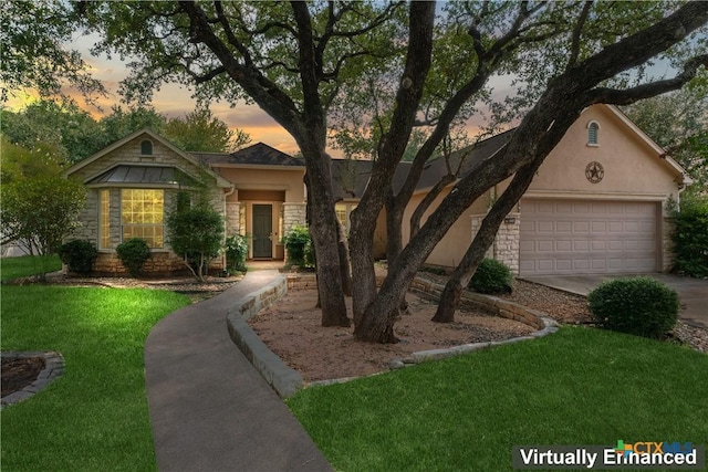 ranch-style house featuring a yard and a garage