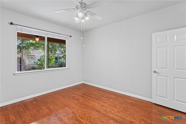 empty room featuring wood-type flooring and ceiling fan