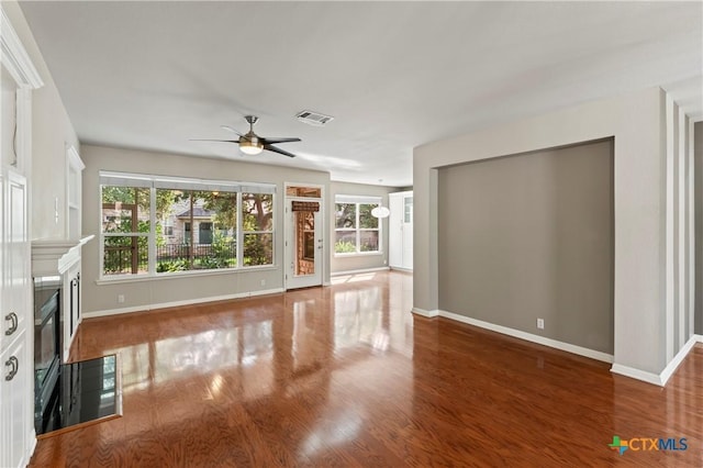 unfurnished living room with hardwood / wood-style floors and ceiling fan