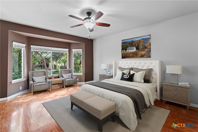 bedroom with wood-type flooring and ceiling fan