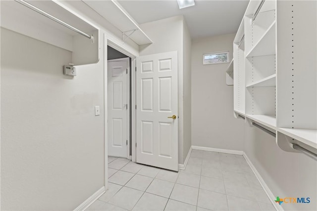 spacious closet featuring light tile patterned floors