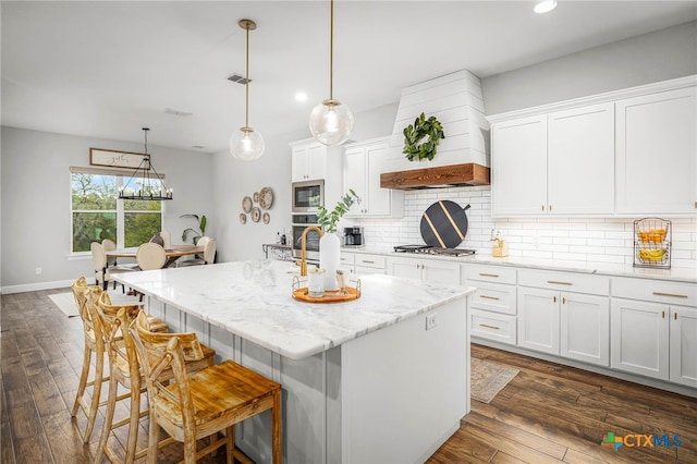 kitchen with white cabinetry, dark wood-style flooring, stainless steel appliances, and decorative backsplash