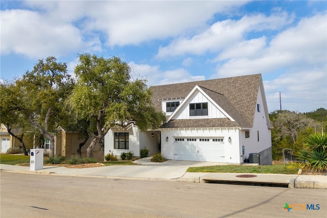 view of front facade featuring a garage, concrete driveway, roof with shingles, cooling unit, and board and batten siding