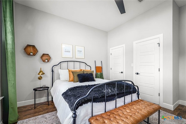 bedroom featuring a ceiling fan, baseboards, and wood finished floors