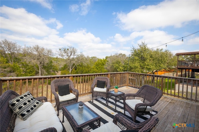 wooden deck with an outdoor living space