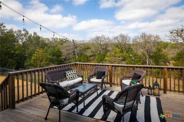 wooden terrace with outdoor lounge area