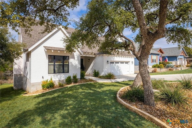 view of front of house with a garage, concrete driveway, and a front yard