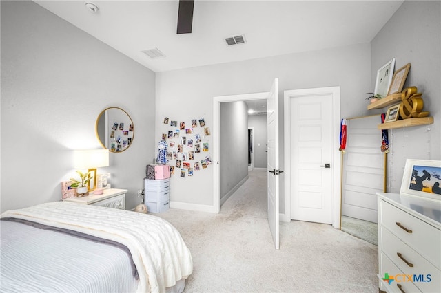 bedroom featuring light carpet, ceiling fan, visible vents, and baseboards