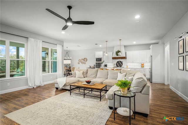 living area featuring dark wood-style floors, baseboards, a ceiling fan, and recessed lighting