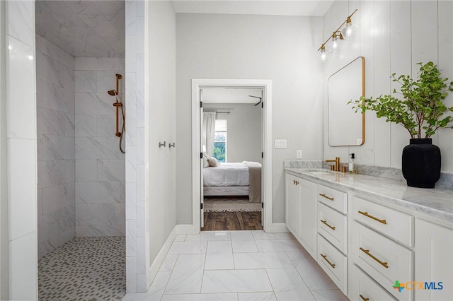 full bathroom featuring baseboards, walk in shower, connected bathroom, and vanity