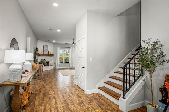 corridor featuring recessed lighting, wood finished floors, visible vents, baseboards, and stairway