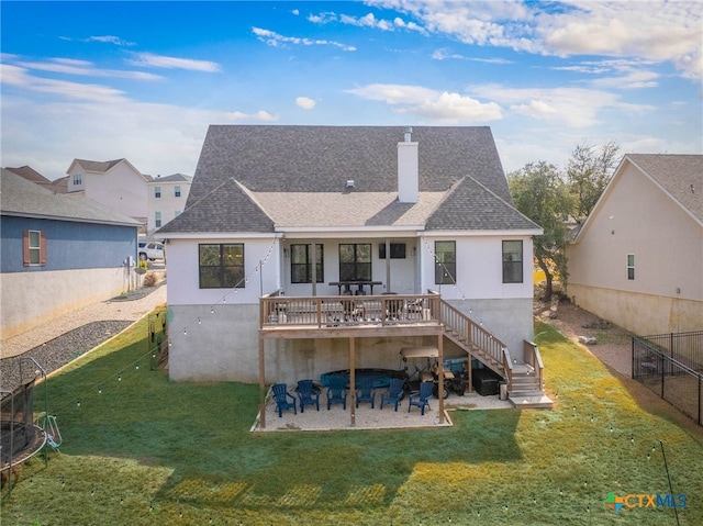 rear view of property with a lawn, a patio, a chimney, stairs, and fence