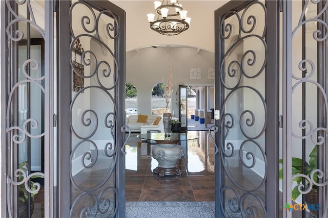 entrance foyer featuring an inviting chandelier and arched walkways