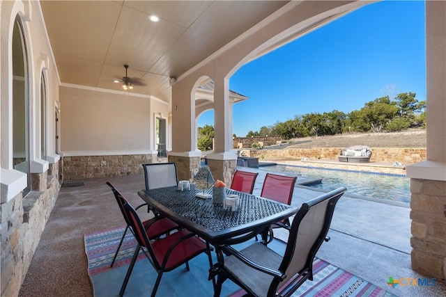 view of patio / terrace with an outdoor pool, a ceiling fan, and outdoor dining space