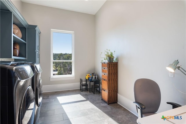 office area featuring baseboards and washing machine and clothes dryer