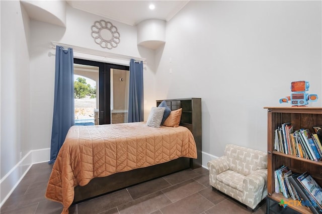 bedroom with french doors, baseboards, and tile patterned floors