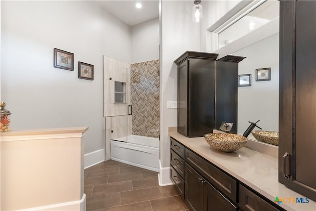 full bathroom featuring bathtub / shower combination, vanity, baseboards, and tile patterned floors