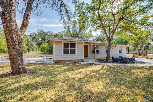 view of front facade with a front yard and a patio area